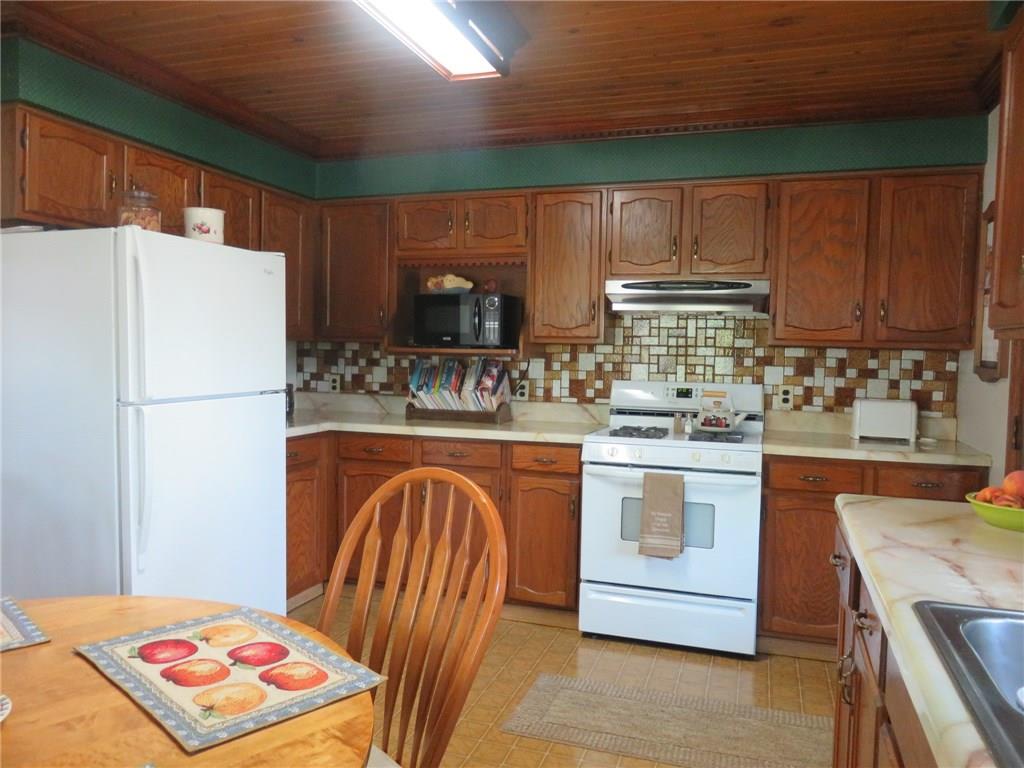 611 New Castle Road Slippery Rock, PA 16057 - Photo 8 of 24 Great counter and cabinet space with tiled backsplash and appliances included.