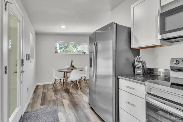 a kitchen with stainless steel appliances granite countertop a refrigerator and a stove top oven