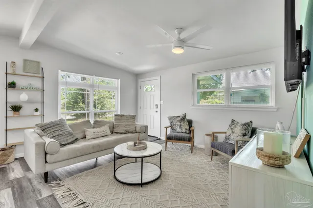 a living room with furniture and a large window
