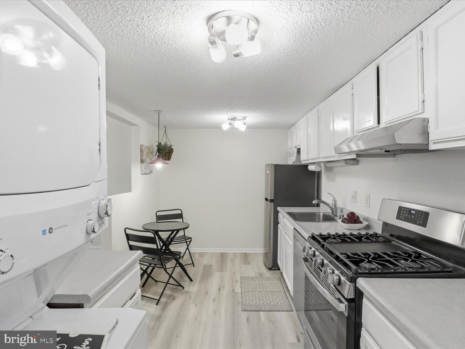 11809 Breton Court, Unit 2B Reston, VA 20191 - Photo 11 of 29 a kitchen with stainless steel appliances a stove a sink and a refrigerator