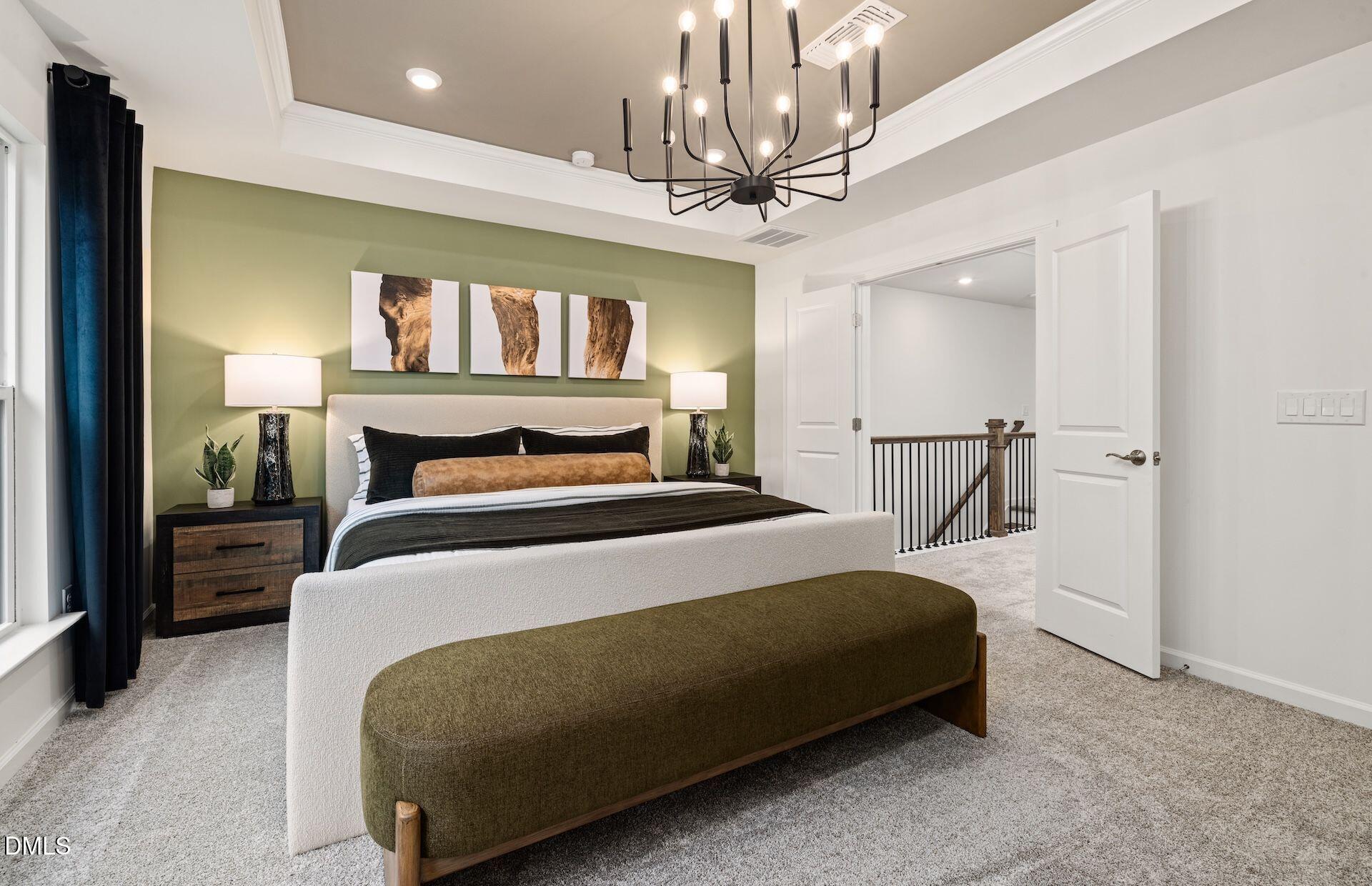 101 Verlands Way Garner, NC 27529 - Photo 9 of 19 a bedroom with a large bed and a chandelier