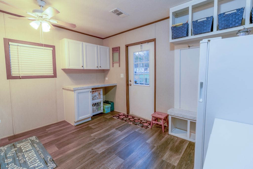 7715 Walnut Tree Lane Plantersville, TX 77363 - Photo 15 of 41 Washroom featuring dark wood-type flooring, ornamental molding, and ceiling fan