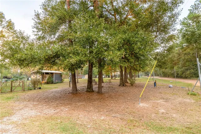 a view of a house with a yard and sitting area