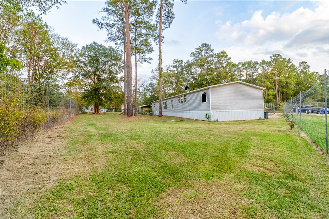 7715 Walnut Tree Lane Plantersville, TX 77363 - Photo 32 of 41 a view of a big yard with large trees