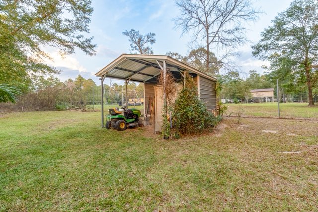 7715 Walnut Tree Lane Plantersville, TX 77363 - Photo 39 of 41 a view of a house with backyard and trees