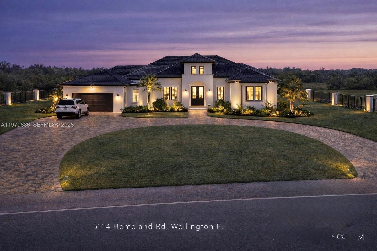 5130 Homeland Road Lake Worth, FL 33449 - Photo 1 of 7 a front view of a house with a yard