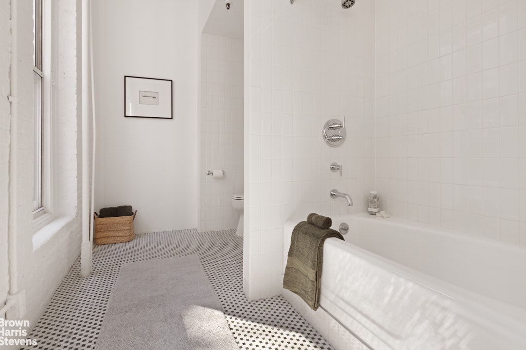 152 Wooster Street, Unit 5B Manhattan, NY 10012 - Photo 11 of 22 a bathroom with a bathtub and shower