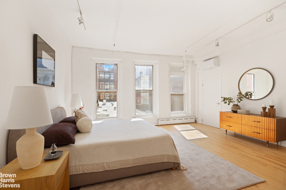 152 Wooster Street, Unit 5B Manhattan, NY 10012 - Photo 7 of 22 a bedroom with bed and a dresser