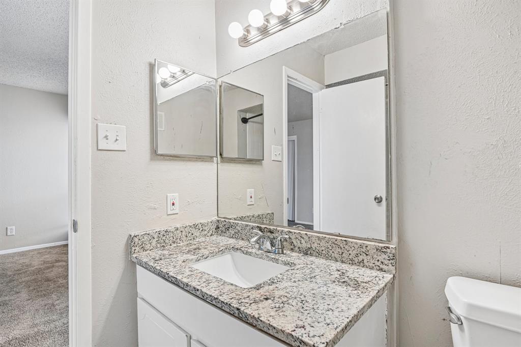 5534 Boca Raton Boulevard, Unit 292 Fort Worth, TX 76112 - Photo 31 of 31 a bathroom with a granite countertop sink and a mirror