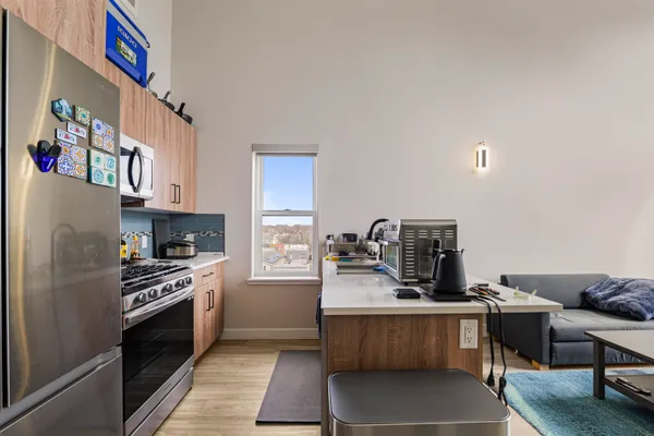 a kitchen with a refrigerator and a stove top oven