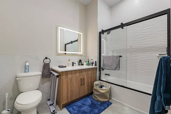 a bathroom with a toilet a sink and mirror