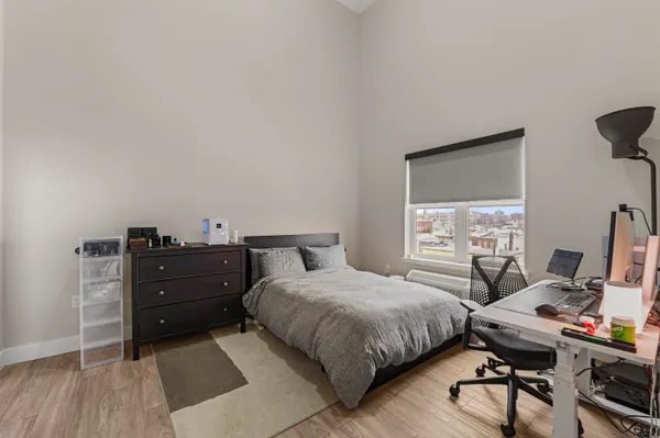 a bedroom with a bed and a desk