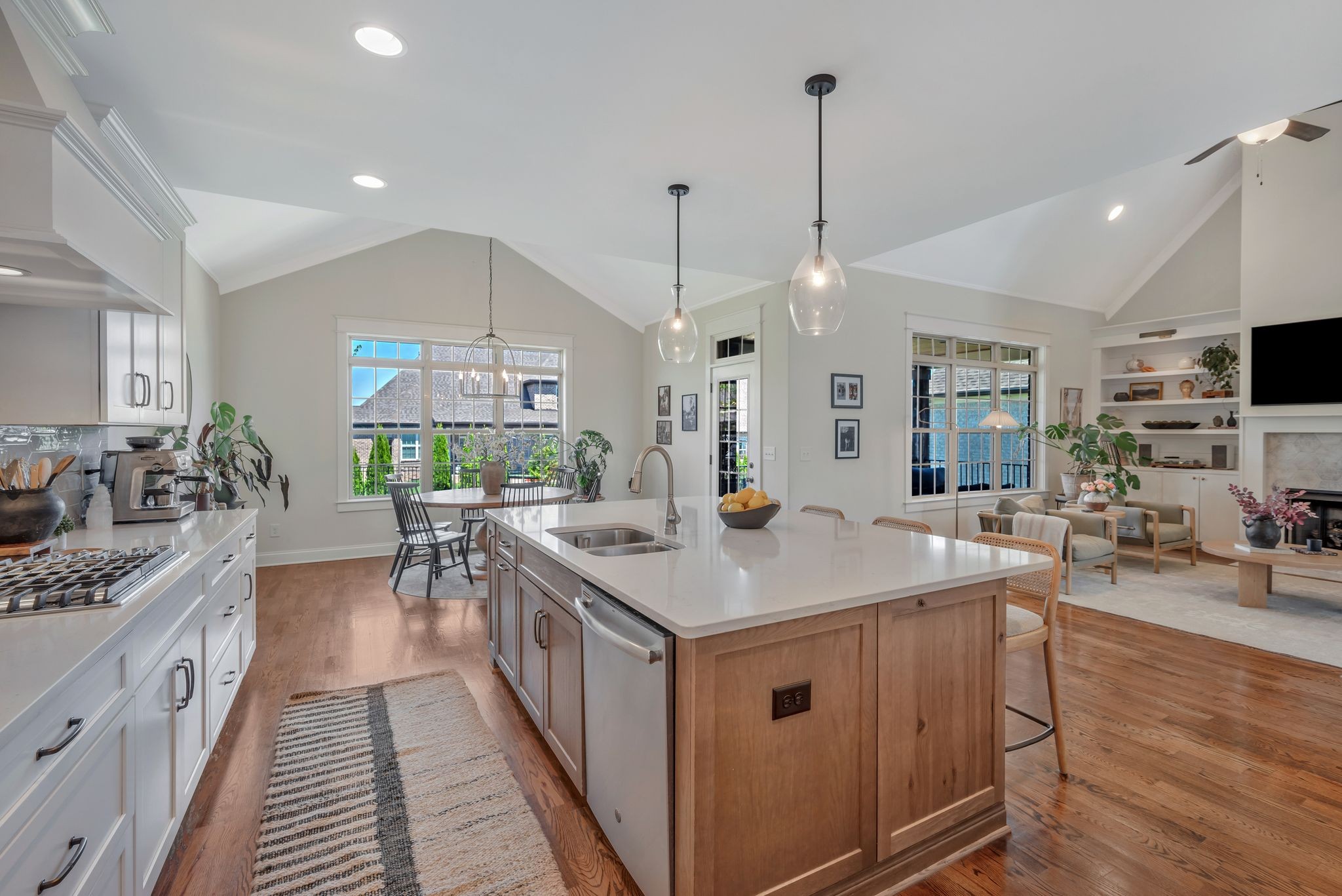 a kitchen with sink stove and wooden floor