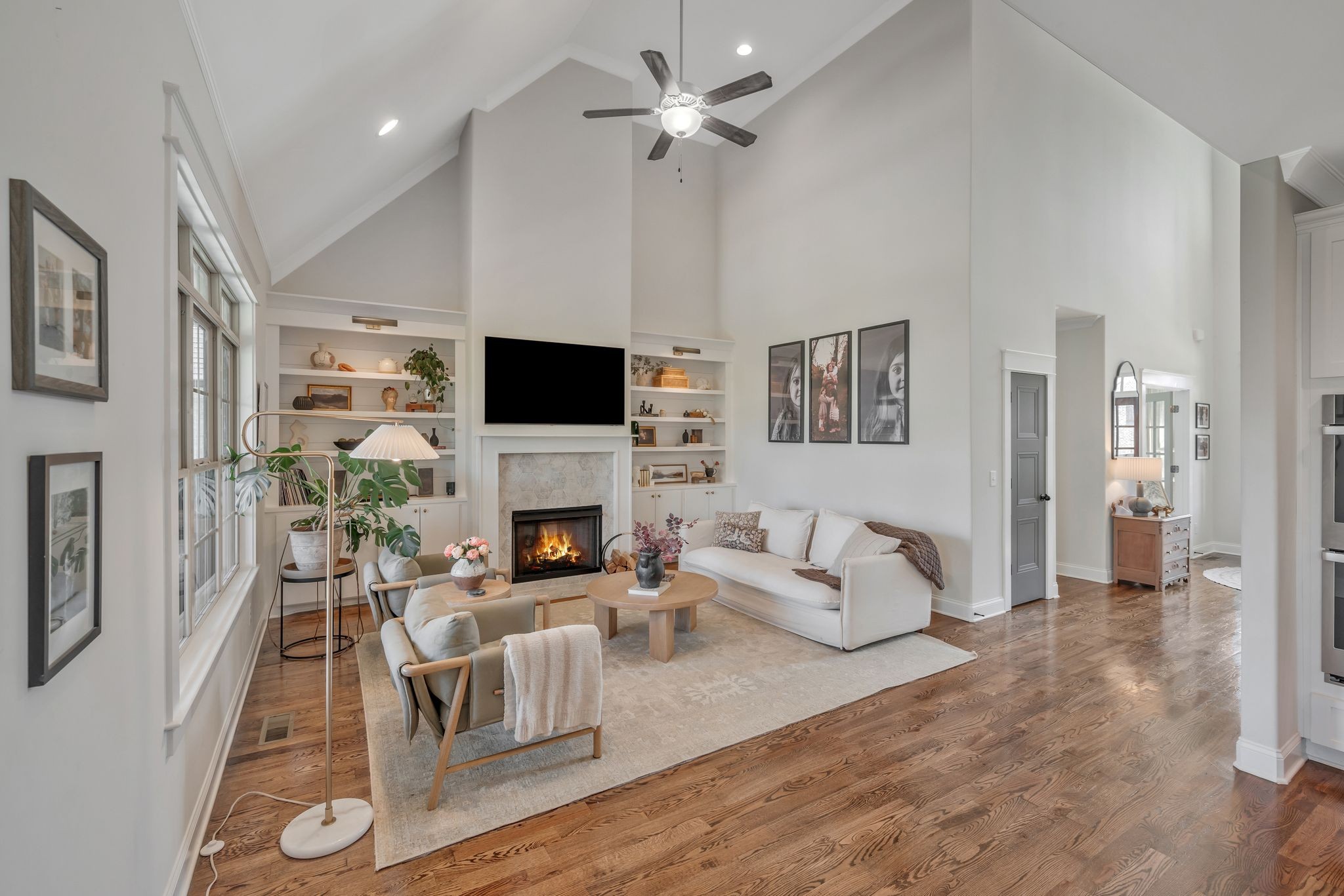 1009 Alpaca Drive Spring Hill, TN 37174 - Photo 25 of 48 a living room with furniture a fireplace and a flat screen tv