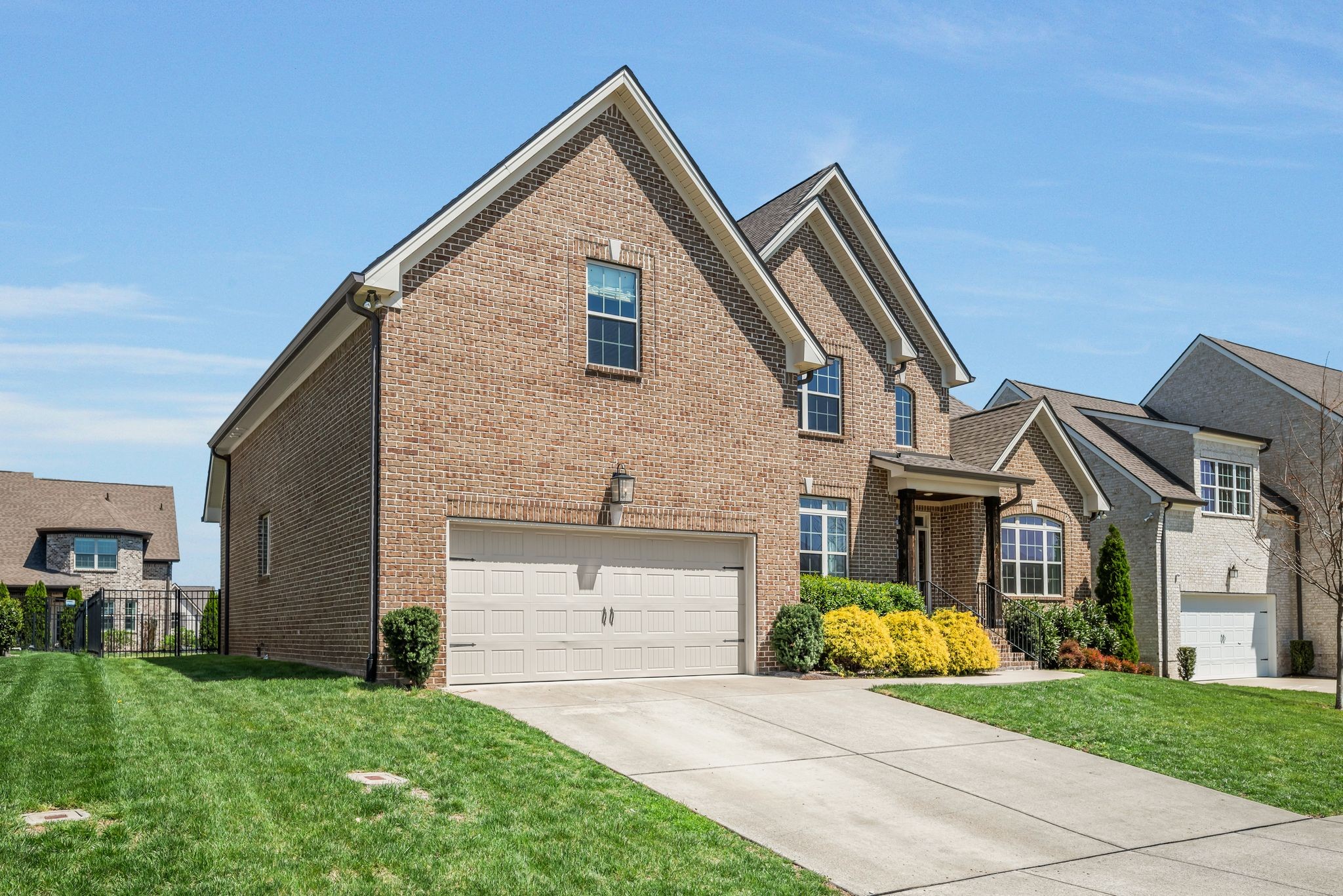 1009 Alpaca Drive Spring Hill, TN 37174 - Photo 4 of 48 a front view of a house with a garden and plants