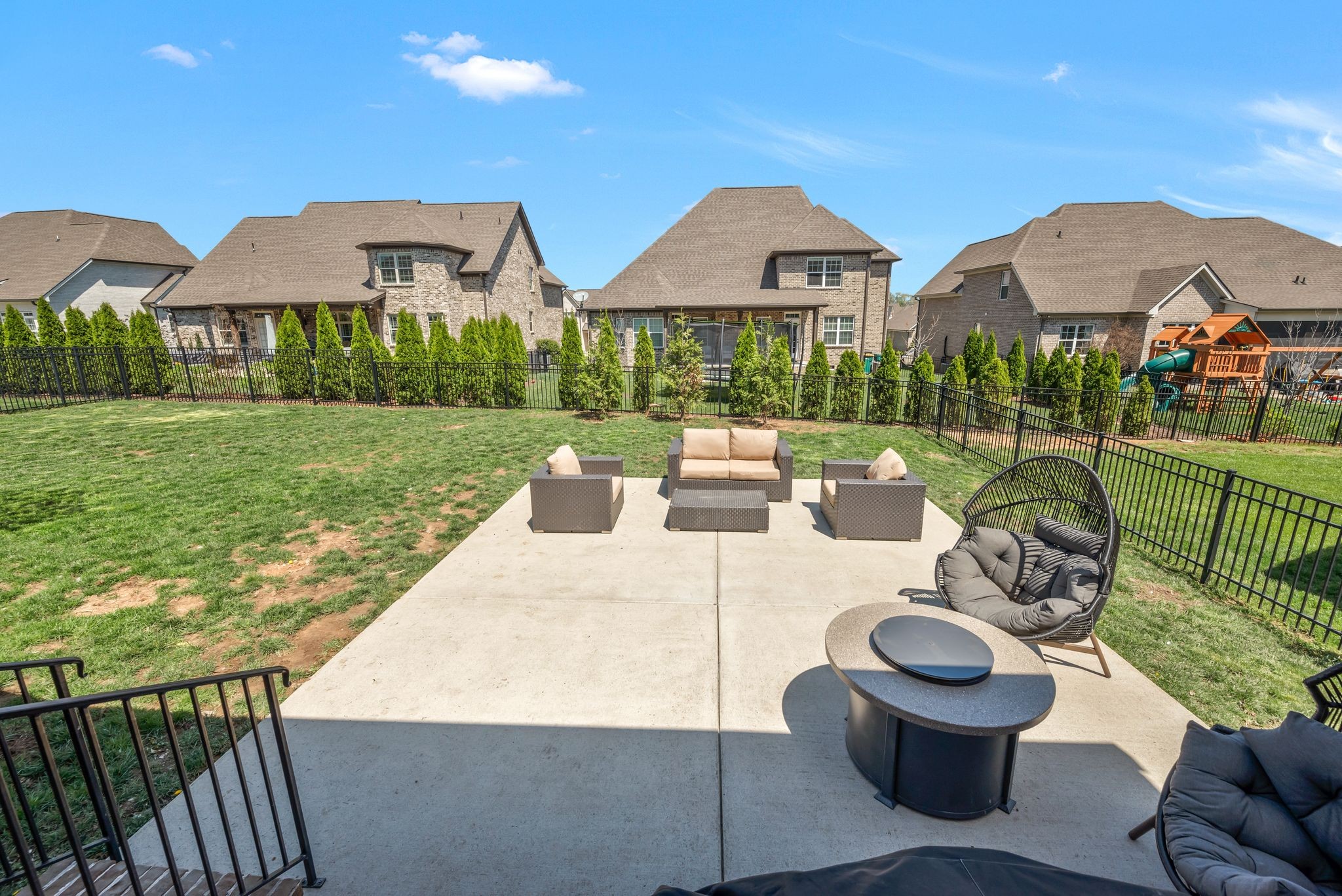 1009 Alpaca Drive Spring Hill, TN 37174 - Photo 47 of 48 a view of a patio with couches chairs potted plants and a yard