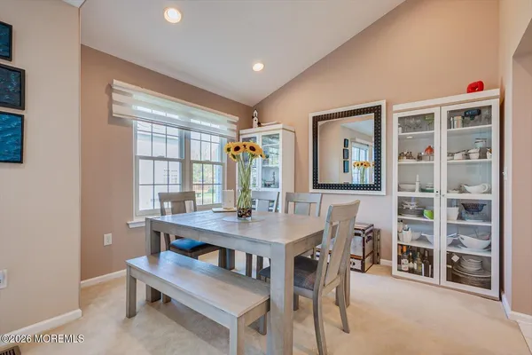 a view of a dining room with furniture and a window
