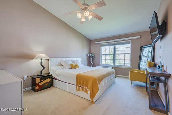 a bed room with a bed and a chandelier