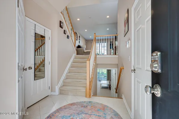 a view of a hallway with entryway and wooden floor