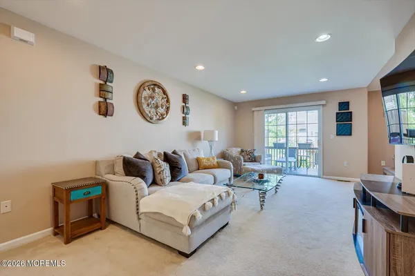 a living room with furniture a window and a table