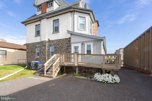 a view of a wooden chairs and a small yard