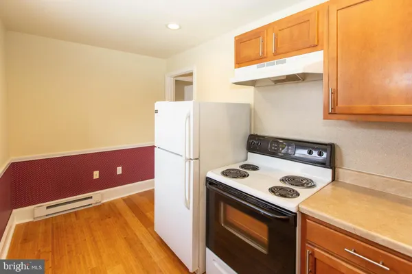 a kitchen with a refrigerator a stove top oven sitting inside of it