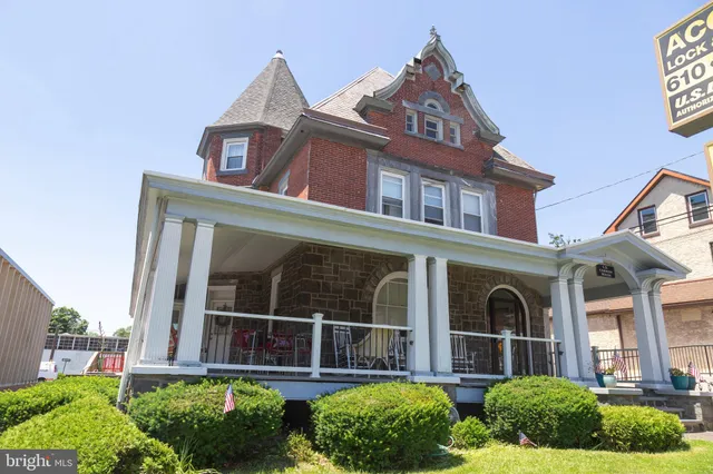 front view of a brick house with a small yard