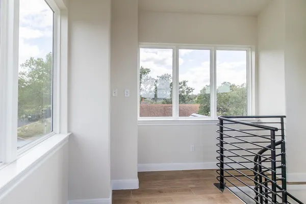 a view of room with window and wooden floor