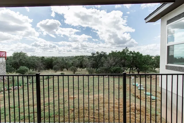 a balcony with trees in the background