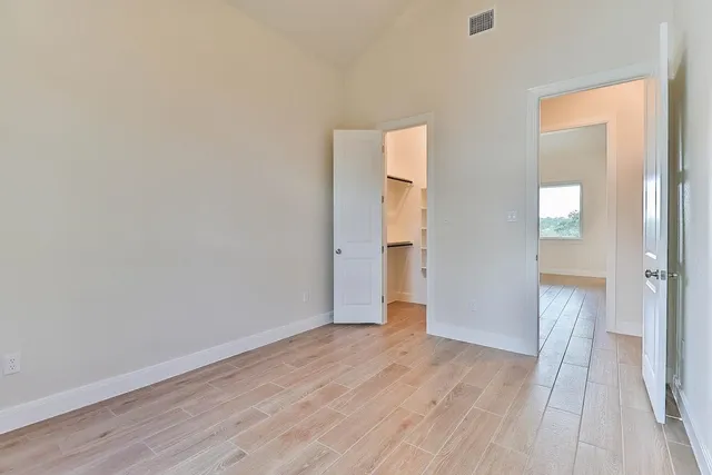 a view of hallway with wooden floor