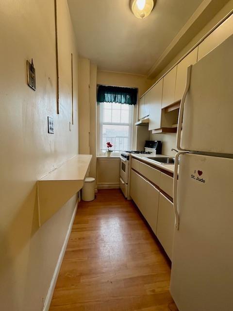 243 78th Street, Unit 6H Brooklyn, NY 11209 - Photo 7 of 19 a kitchen with sink cabinets and window