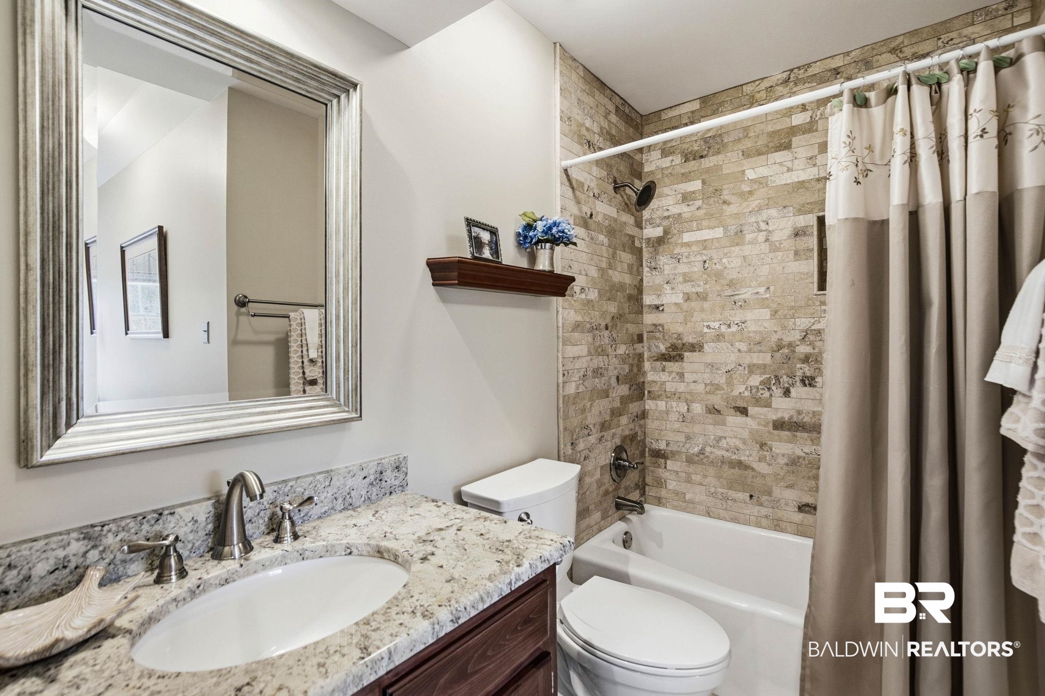 31515 Rhett Drive Spanish Fort, AL 36527 - Photo 45 of 100 This bathroom as granite countertops, tiled shower/tub combination and in the dormer area fits a makeup table or desk.