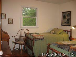 263 Docks Road Hendersonville, NC 28792 - Photo 8 of 12 a bed sitting in a bedroom next to a window