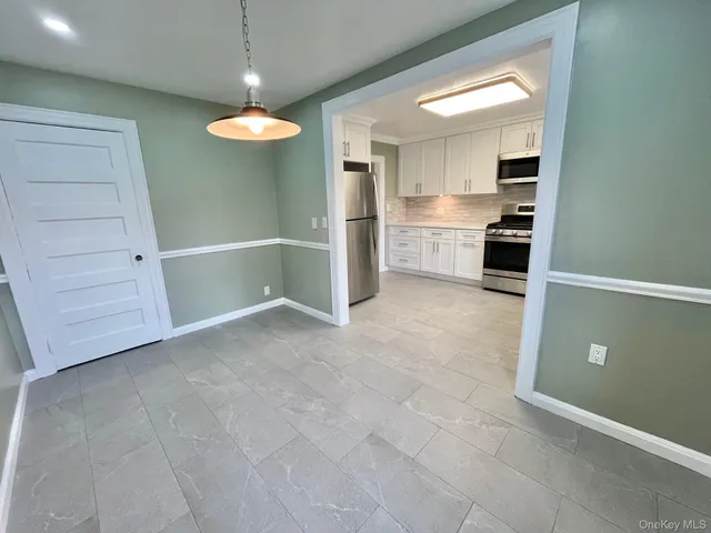 a view of a kitchen with a sink and dishwasher cabinets