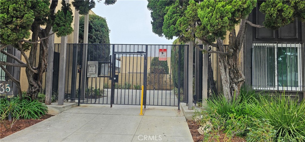 5535 Ackerfield Avenue, Unit 9 Long Beach, CA 90805 - Photo 2 of 19 a view of a gate of a house with a small yard and potted plants