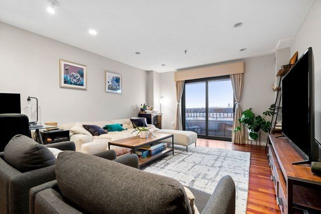 a bedroom with two beds and a flat screen tv