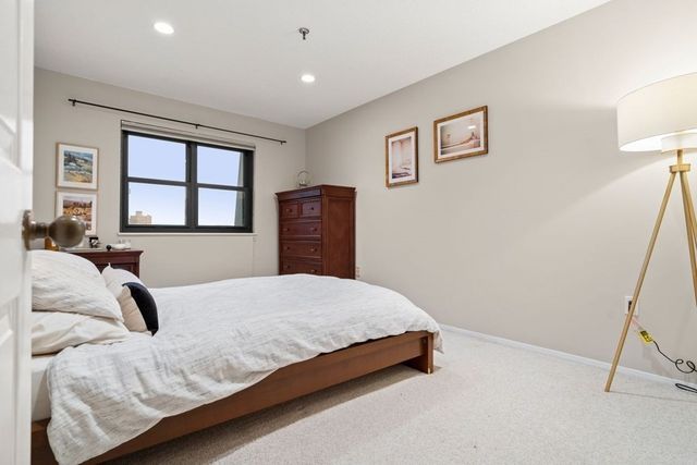 a bedroom with a bed and a dresser