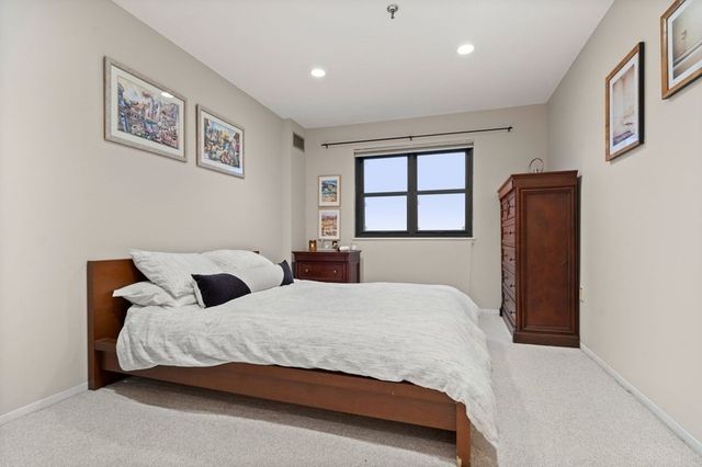 a bedroom with a large bed and a window