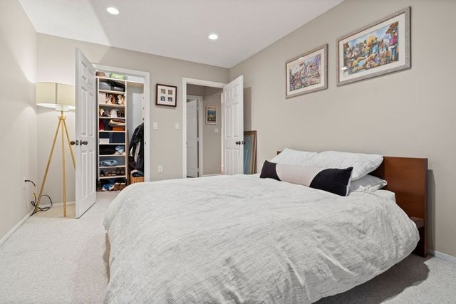 a bedroom with a bed and a walk in closet