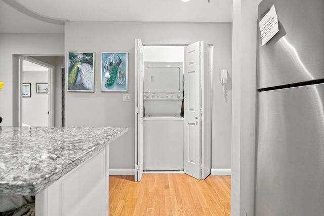 a bathroom with a granite countertop sink and mirror