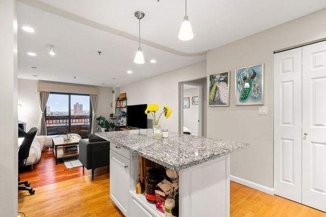 a view of kitchen island with granite countertop living room