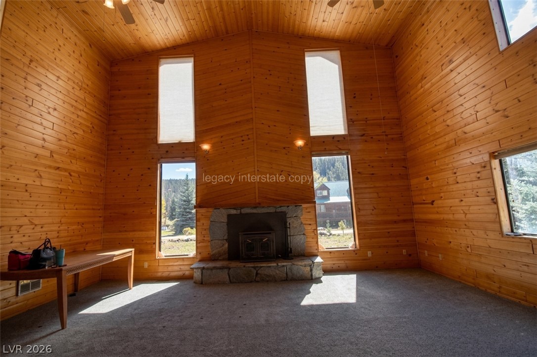 1129 East Ponderosa Road Hatch, UT 84735 - Photo 6 of 47 Rich wood paneling and a soaring stone fireplace create an inviting cabin-like atmosphere.