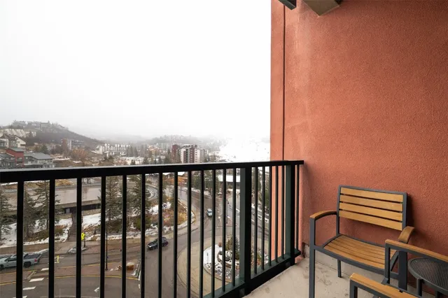 a view of a balcony with wooden benches