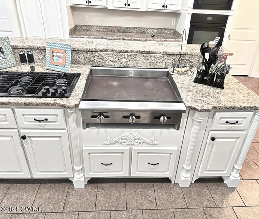 a stove top oven sitting inside of a kitchen