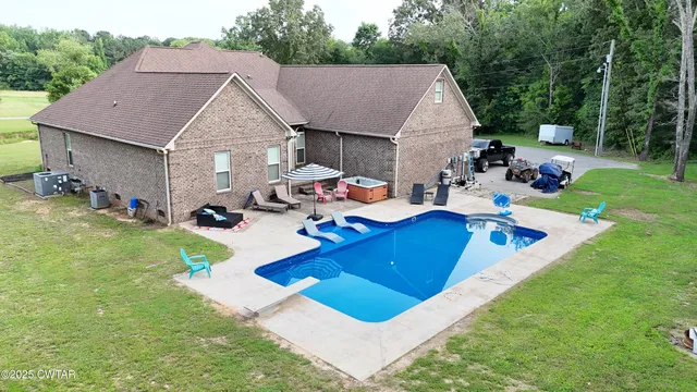 a view of a house with pool and chairs