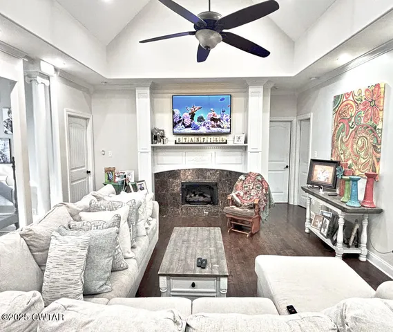 a living room with furniture a fireplace and a window