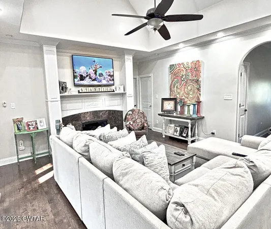 a living room with furniture and a painting on the wall