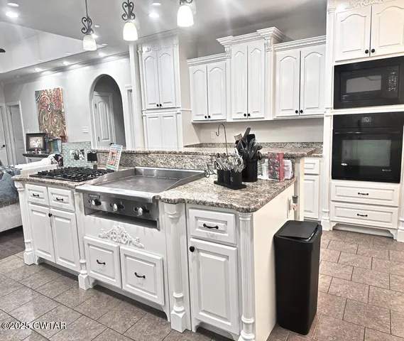 a kitchen with white cabinets and white appliances