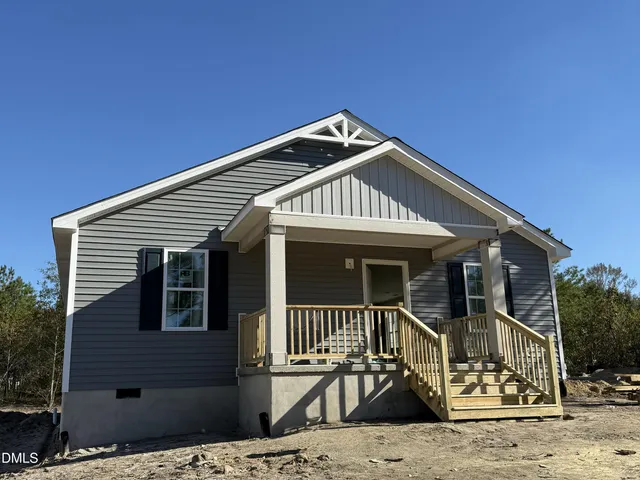 a front view of a house with a wooden fence