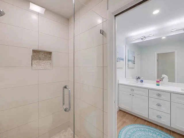 a kitchen with stainless steel appliances kitchen island granite countertop a refrigerator stove and sink